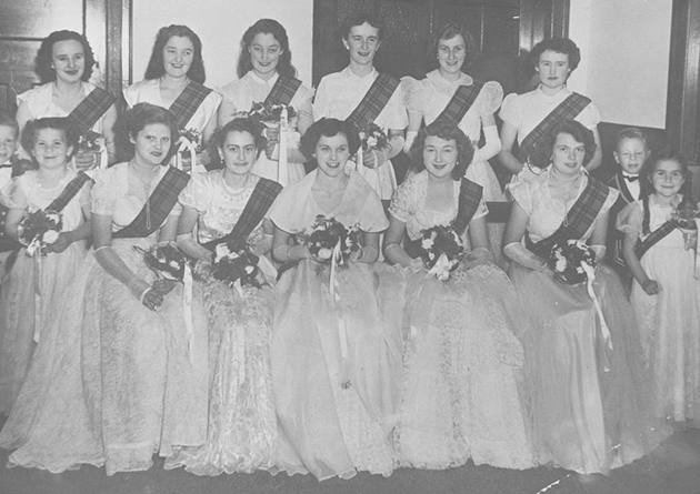 Debutantes seated and holding bouquets for a formal photograph, 1952